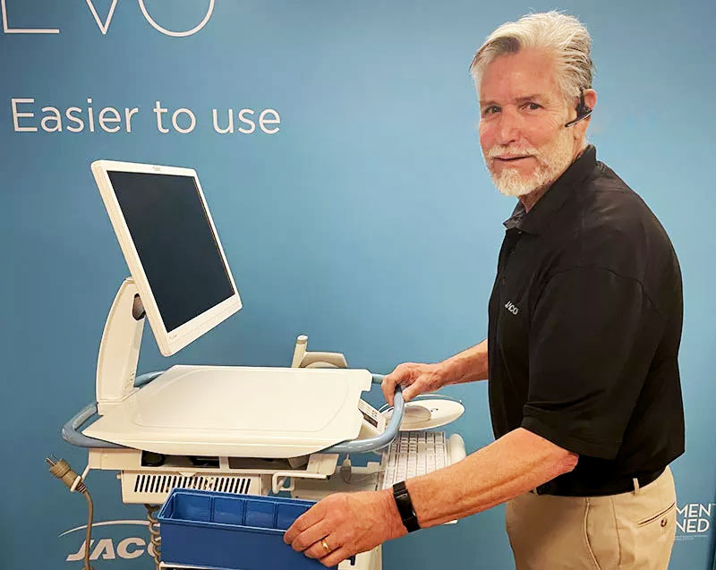 JACO staff member standing next to an EHR data entry cart with accessories